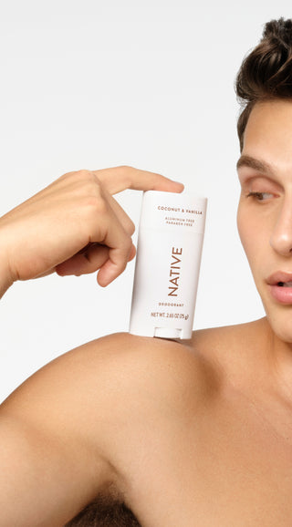 Person holding a Native deodorant stick